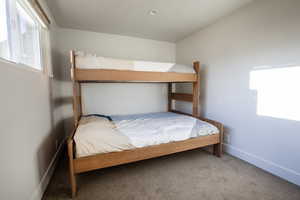 Carpeted bedroom featuring baseboards
