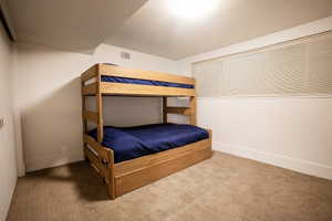Bedroom featuring baseboards, carpet, and visible vents