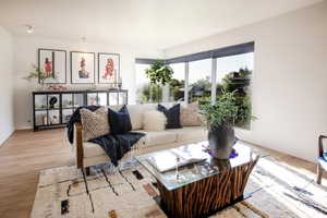 Living room with light wood-style floors and baseboards