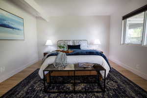 Bedroom with baseboards and wood finished floors
