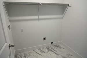 Laundry room with marble finish floor, hookup for an electric dryer, baseboards, and laundry area