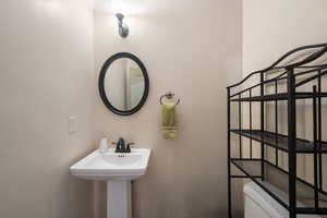 Half bathroom with toilet and a sink