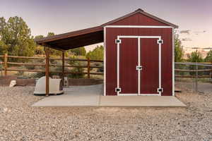 View of shed with a fenced backyard