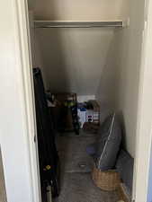 Interior space with carpet and lofted ceiling