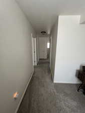Corridor with carpet floors and baseboards