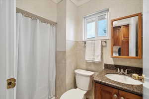 Full bathroom featuring vanity, ornamental molding, toilet, and a shower with shower curtain