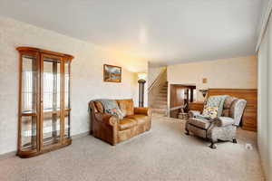Living room with carpet floors and stairway