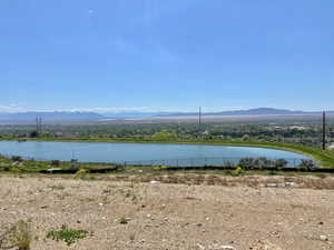 Water view with fence and a mountain view