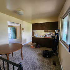 Home office with baseboards, visible vents, and carpet