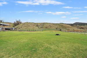 View of yard with fence and a mountain view