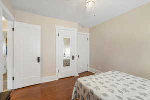 Bedroom featuring a ceiling fan, baseboards, and wood finished floors