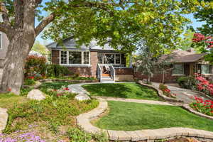 Bungalow with a front yard and brick siding