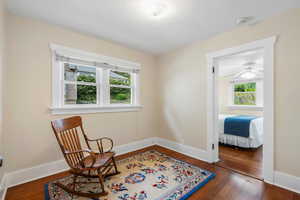 Sitting room with baseboards and wood finished floors