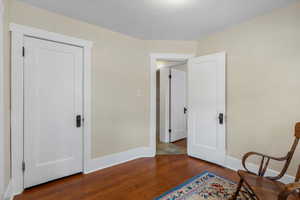 Sitting room with baseboards and wood finished floors