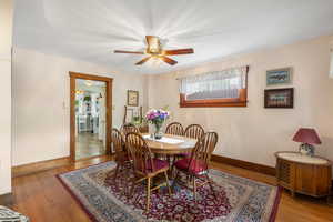 Dining space featuring baseboards, ceiling fan, and wood finished floors