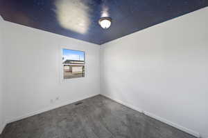 Unfurnished room with visible vents, baseboards, and carpet floors