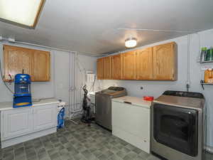 Laundry area with a sink, cabinet space, and washer and dryer