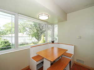 Unfurnished dining area with visible vents and baseboards