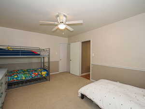 Bedroom featuring carpet floors, ceiling fan, and baseboards