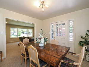 Dining room featuring baseboards and carpet