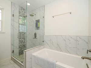 Bathroom with marble finish floor, recessed lighting, baseboards, a shower stall, and a bath