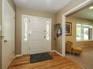 Entryway with baseboards and light wood finished floors