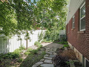 View of yard with fence and central AC unit