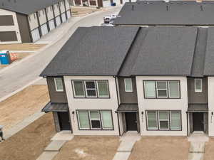 Rear view of property with stucco siding, a mountain view, metal roof, and a standing seam roof
