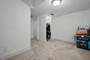Basement featuring baseboards and carpet