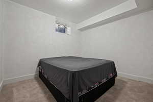 Carpeted bedroom featuring baseboards