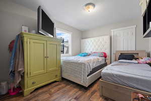 Bedroom with dark wood-style floors