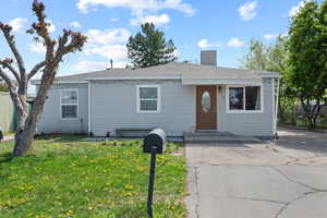 Bungalow featuring fence, a front yard, and a chimney