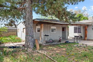 Rear view of property featuring a patio and board and batten siding