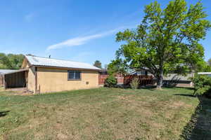 View of yard featuring an outbuilding and a carport