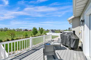 Deck featuring a lawn and area for grilling