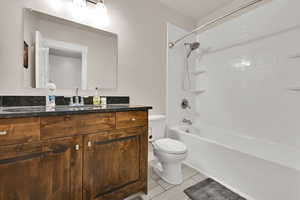 Bathroom with shower / bath combination, vanity, and toilet