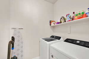 Washroom with laundry area and washing machine and dryer