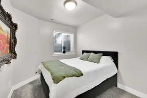 Carpeted bedroom with visible vents and baseboards