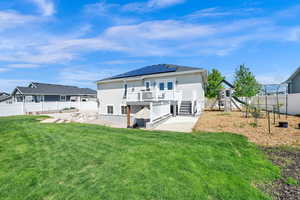 Rear view of property featuring a fenced backyard, a wooden deck, and stucco siding
