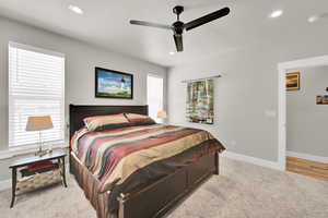 Carpeted bedroom with recessed lighting, baseboards, and ceiling fan