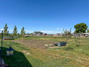 View of yard featuring fence and a garden