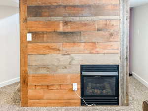 Interior details with a glass covered fireplace and baseboards