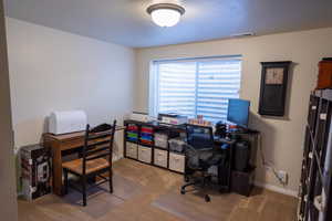 Flex space (bedroom 4) used as home office featuring visible vents, a textured ceiling, and baseboards