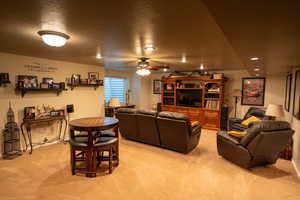 Living room with light colored carpet, a ceiling fan, and recessed lighting
