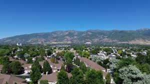 Aerial view of property featuring both residential and mountain views
