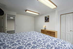 Tiled bedroom with a closet