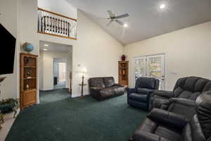 Carpeted living room with baseboards, a ceiling fan, recessed lighting, and high vaulted ceiling