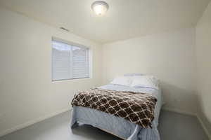 Bedroom featuring baseboards and visible vents