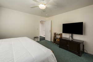 Bedroom featuring carpet floors, a ceiling fan, and baseboards
