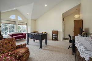 Playroom featuring carpet floors, recessed lighting, a chandelier, and high vaulted ceiling
